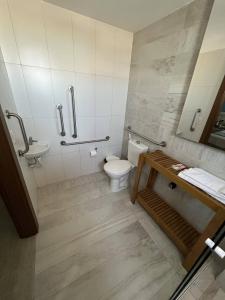 a bathroom with a toilet and a sink at Golden Towers Hotel in Macaé