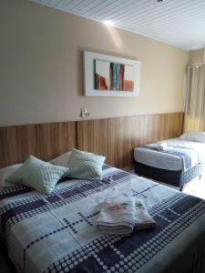 Un pat sau paturi într-o cameră la Pousada Rota das Praias