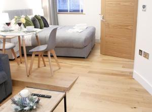 Habitación con cama, mesa y comedor. en Lovely Studio Apartment with access for Wheel-chairs in Sydenham, en Forest Hill