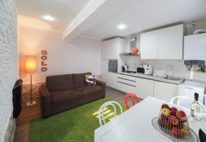 a kitchen and a living room with a couch and a table at For You Apartments Gold & Silver in Sibiu +41 photos