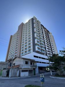 a large apartment building with a parking meter in front of it at Golden Towers Hotel in Macaé