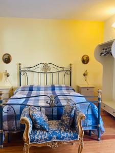 a bedroom with a blue bed with a chair at Casevacanza Trentovamare in Agropoli +31 photos