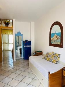 a bedroom with a bed and a blue refrigerator at Casevacanza Trentovamare in Agropoli