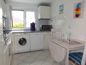 a kitchen with a sink and a washing machine at Ferienwohnung Heike in Rabel