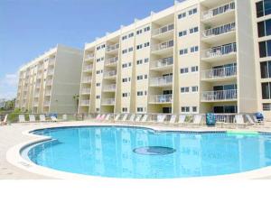 a swimming pool in front of a large apartment building at Beach House 603D- Rest Ashore in Destin