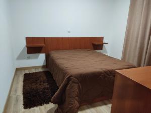 a bed in a room with a brown bedspread at Holiday home and weekends, 4 in Esposende