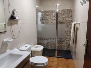 a bathroom with a shower and a toilet and a sink at Holiday home and weekends, 4 in Esposende +17 photos