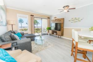 a living room with a couch and a table at Stunning Views!!-Oceanfront Villa-Heated Pool-Private Balcony-Tiki Bar-Walk to Coligny Plaza in Hilton Head Island