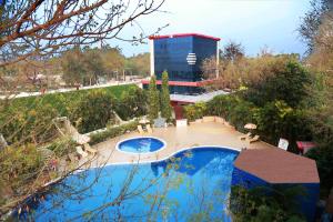 a view of a swimming pool with a building in the background at Sambodhi Retreat in Bodh Gaya