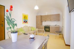 a kitchen and living room with a table and a couch at Castle Living in Catania