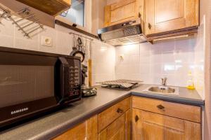 a kitchen with a microwave and a sink at Edelweiss 0407 in Middelkerke