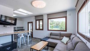 a living room with a couch and a table at Cortijo Villa Maroma Órgiva by Ruralidays in Órgiva