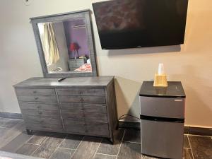 a dresser with a mirror next to a dresser with a dresser at Miami Inn & Suites in Chicago