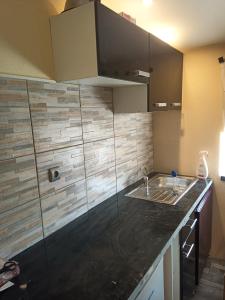 a kitchen with a sink and a counter top at Studio 2 ou 3 places in Verdun-sur-le-Doubs