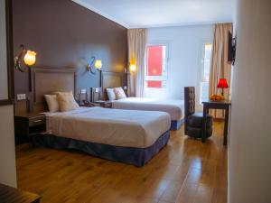 Katil atau katil-katil dalam bilik di Hotel L'Aéroport