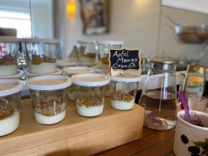 a bunch of food in jars on a table at Haus Kap Horn in Juist