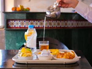 a tray of food on a table with a plate of food at Hotel L'Aéroport in Nador +36 photos