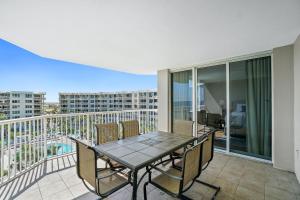 a patio with a table and chairs on a balcony at Destin West - Heron in Fort Walton Beach +23 photos