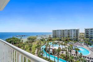 a view of the pool and beach from the balcony of a resort at Destin West - Heron in Fort Walton Beach