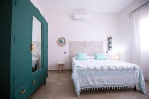 A bed or beds in a room at La Casa di Zia Dedera