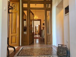 a hallway with wooden doors and a rug at Heritage Apartment Park Royal Residence in Opatija