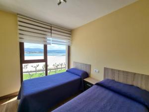 Posteľ alebo postele v izbe v ubytovaní Foz Playa Rapadoira - 3 dormitorios