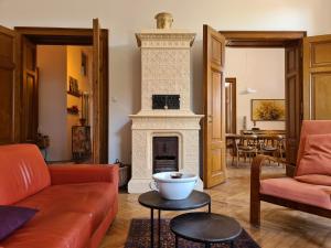 a living room with a fireplace and a couch at Heritage Apartment Park Royal Residence in Opatija