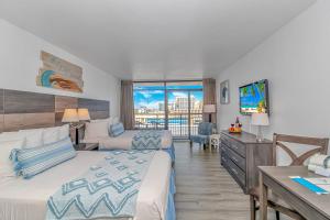 a hotel room with two beds and a television at Ocean View Studio Landmark 907 in Myrtle Beach +28 photos