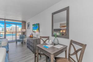 a living room with a desk and a table with chairs at Ocean View Studio Landmark 907 in Myrtle Beach