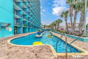a swimming pool at a hotel with people in a swimming pool at Ocean View Studio Landmark 907 in Myrtle Beach