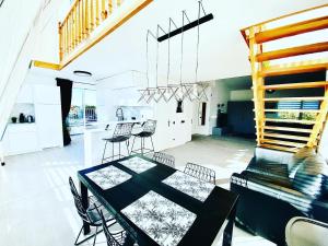 a dining room and kitchen with a table and chairs at Panoramic View PH By The Sea in Palanga +20 photos
