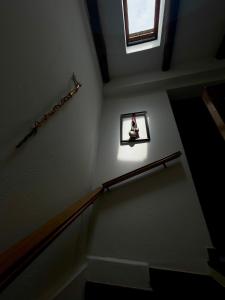 a stairway with a picture of a witch on the wall at Casa Veronica - accogliente casa su due piani nel cuore del borgo in Làconi +13 photos