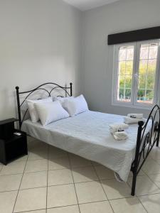 a bed with white sheets and white pillows in a bedroom at JET, luxury appartment 20m from the beach in Kinion