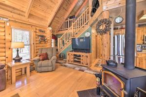 a living room with a fireplace and a tv in a cabin at 2-Acre Cabin in Pinetop-Lakeside with Fenced Yard in Pinetop-Lakeside