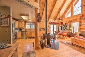 a large kitchen and living room in a log cabin at 2-Acre Cabin in Pinetop-Lakeside with Fenced Yard in Pinetop-Lakeside