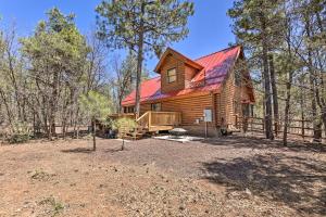 a cabin in the woods with a red roof at 2-Acre Cabin in Pinetop-Lakeside with Fenced Yard in Pinetop-Lakeside