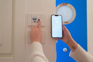 a person holding a cell phone in front of a lightswitch at Lampara Mare in Vico Equense