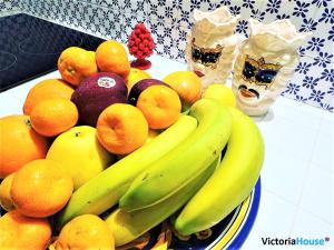 a bowl of fruit with bananas oranges and other fruits at Victoria House Scopello in Scopello
