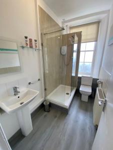a bathroom with a shower and a sink and a toilet at Grassmarket apartment in Edinburgh