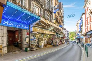 a street with shops on the side of a road at Hotel Acapulco in Lourdes