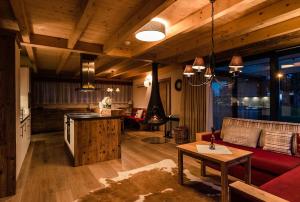 a kitchen and living room with a couch and a table at Villa Resort & Luxury Chalet 6 in České Budějovice
