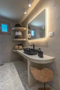 a bathroom with a sink and a mirror at Ocean Pearl Luxurious Suite in Pachaina
