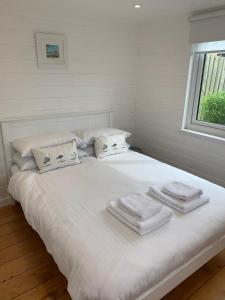 a white bed with towels on top of it at The Pod in Kingsbridge