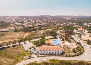 an aerial view of a town with a resort at Hotel Vale Da Telha in Aljezur