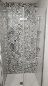 a shower stall with a glass door with a shower at El Paraiso in Aguadulce +15 photos