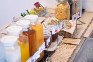a table topped with jars of honey and food at Hotel Vale Da Telha in Aljezur +31 photos