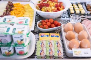 a buffet of food with eggs and fruit and other foods at Hotel Vale Da Telha in Aljezur