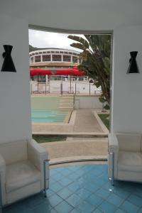 a room with two chairs and a soccer stadium at Ganimede Hotel in Sperlonga