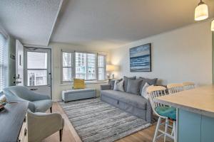 a living room with a couch and a table at Walk to Maryland Beach Coastal Condo with Balcony in Ocean City