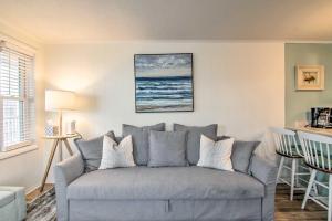 a living room with a gray couch in a room at Walk to Maryland Beach Coastal Condo with Balcony in Ocean City +18 photos